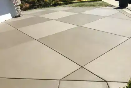 Clean broom-finish concrete driveway with control joints